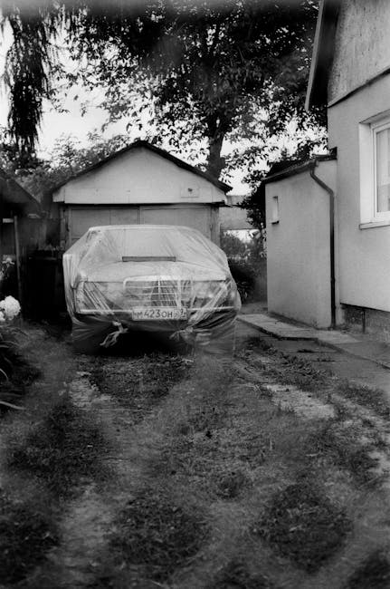 A covered classic car symbolizing secure asset storage